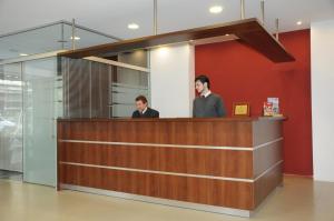 two men standing at a reception desk at Hotel California in Montevideo