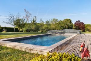a swimming pool with a glass dome on a wooden deck at Longère Pierre De Ronsard piscine in Rilly-sur-Loire