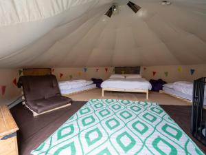 a room with a tent with a bed and a chair at YHA Conwy in Conwy