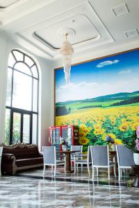 a living room with a large painting on the wall at Sunflower Hotel in Nhơn Trạch
