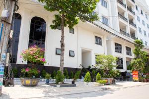 a building with plants in front of it at Sunflower Hotel in Nhơn Trạch