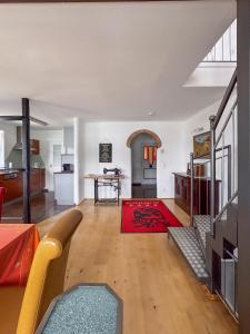 a living room with a red rug on the floor at Ferienhaus Pippan in Velden am Wörthersee