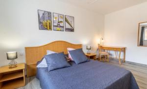 a bedroom with a blue bed and a desk at Gîtes Les 2 Fontaines in Marans +80 photos