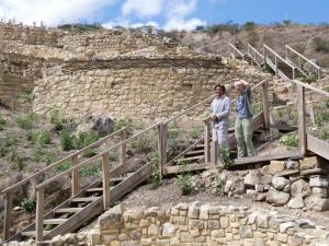 two people standing on a staircase in front of a stone wall at JJ Guest House Kuelap in Nuevo Tingo