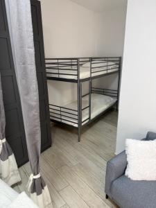 a room with a bunk bed and a couch at San Nicolò in Umag