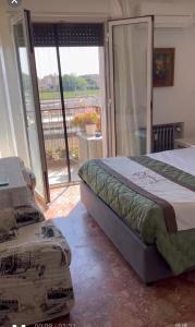 a bedroom with a bed and a sliding glass door at stazione Lina house in Mestre +8 photos