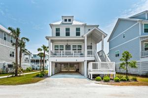 a large white house with a white porch at Sitting Bayside in Santa Rosa Beach