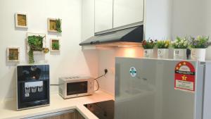 a kitchen with a microwave on a counter at Majestic Cottage in Ipoh