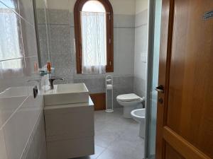 a bathroom with a sink and a toilet at Les Lauriers, chambre d'hôtes in Siamanna +52 photos