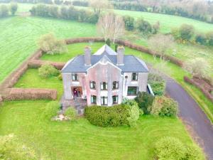 an aerial view of a large house in a field at House in the countryside in Cork