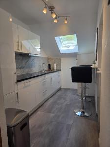 a kitchen with a sink and a chair in a room at Tifra-living in Hardenberg +17 photos