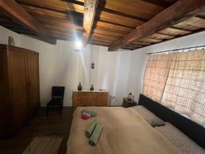 a bedroom with a large bed and a wooden ceiling at Bedi Vendégház in Nagybakónak