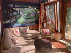 a living room with a couch and a large window at Superbe maison calme au centre ville in Blois