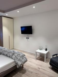 a bedroom with a bed and a tv on a wall at Casa Edoardo in Cavedine