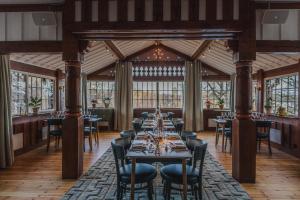 a dining room with a long table with chairs at Badhotellet Villa Berg in Norrtälje