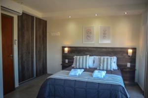 a bedroom with a large bed with two pillows at Apart Hotel Los alazanes in Capilla del Monte +42 photos