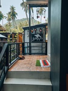 a balcony of a house with a sign on it at Koh Tao Silver Na’s Hostel in Ko Tao