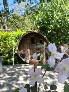 a mirror in front of a house with flowers at Le Temple Ysambre in Malansac