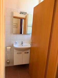 a bathroom with a sink and a mirror at Stiftung Kloster und Kaiserpfalz Memleben in Kaiserpfalz