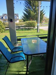 a glass table and chairs on a porch at Vacation House Loreta in Sveti Rok