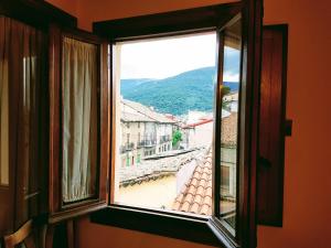 an open window with a view of a city at Casa Rural TioMoreno by Naturadrada in La Adrada