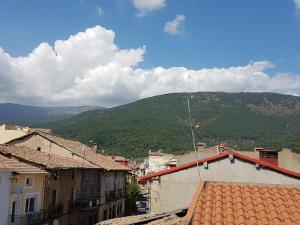 a view of a town with mountains in the background at Casa Rural TioMoreno by Naturadrada in La Adrada +33 photos