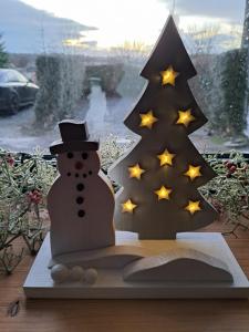 a christmas decoration of a snowman and a christmas tree at Darrell Cottage in Kanturk