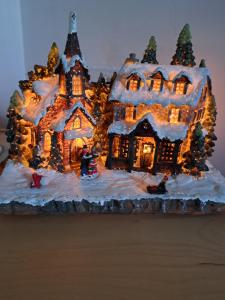 a gingerbread house is lit up with christmas lights at Darrell Cottage in Kanturk