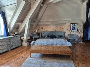 a bedroom with a bed and a wooden floor at Le Berthoir in Pélussin