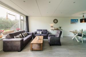 a living room with two couches and a table at Repos (6p) in Nes