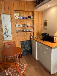 a kitchen with a counter and a table and a chalkboard at Bed and B Les Truffières in Trémolat +6 photos
