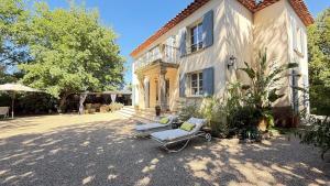 a house with a chair sitting outside of it at La Largarde in Six-Fours-les-Plages