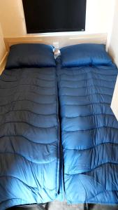a blue comforter and pillows on a bed at Beach Resort Kamperland - 765 in Kamperland
