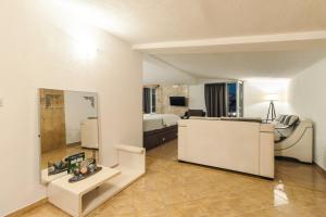 a living room with a bed and a mirror at Wiena Apartments in Ulcinj