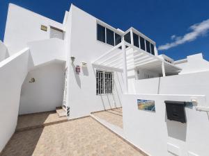 a white house with white walls and stairs at Casa Donna in Playa Honda