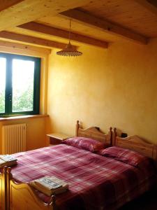 a bedroom with a bed and a window at Normena Mountain Residence in Tizzano Val Parma