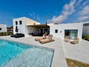 a house with a swimming pool in front of a house at Faragas Hill in Angairiá