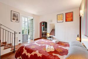 a bedroom with a bed with shoes on it at Tuscan Sunrise Home in Monteriggioni