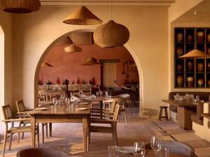 a restaurant with tables and chairs in a room at Zannier Île de Bendor in Bandol