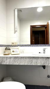 a bathroom with a sink and a mirror at Hotel Finca Los Venancios in Bones +29 photos