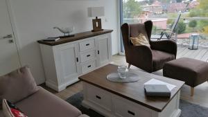 a living room with two chairs and a coffee table at Ferienwohnung Boddenblick-Vilm in Putbus +18 photos