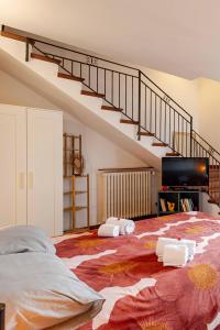 a bedroom with a large bed and a staircase at Tuscan Sunrise Home in Monteriggioni
