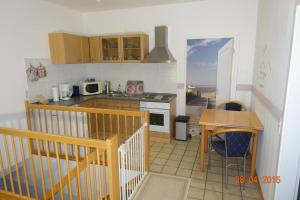 a kitchen and dining room with a table and a microwave at Heidehof Auenland in Wietzendorf