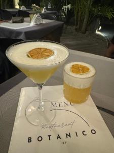 a martini and a drink on a table at Tucan Resort & Spa in Paramaribo