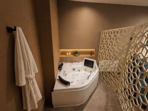 a bathroom with a bath tub in a room at Abalú Collection Suites Gran Via in Madrid +68 photos