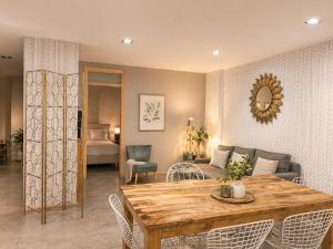 a living room with a table and a couch at Abalú Collection Suites Gran Via in Madrid