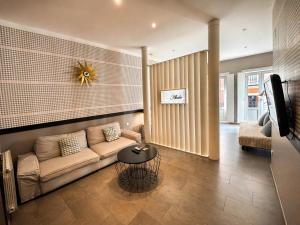 a living room with a couch and a table at Abalú Collection Suites Gran Via in Madrid