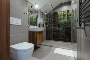 a bathroom with a toilet and a shower and a sink at Przystań Leśniów in Żarki +36 photos