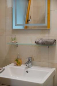 a bathroom with a white sink and a mirror at Bárka a Tiszához apartman in Tiszaug +53 photos