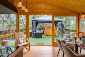 a living room with a tent and a patio at Bárka a Tiszához apartman in Tiszaug